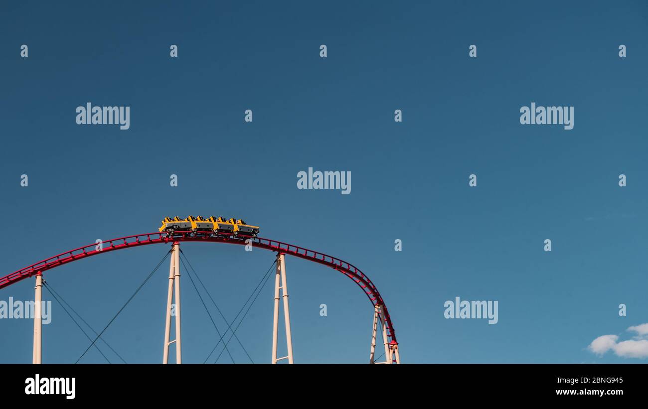 Low angle shot of a roller coaster captured under the clear blue sky Stock Photo