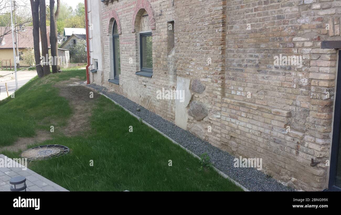 Building old stone wall in the city Stock Photo
