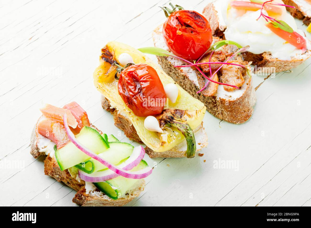 Set of delicious Italian bruschettas with grilled vegetables. Stock Photo