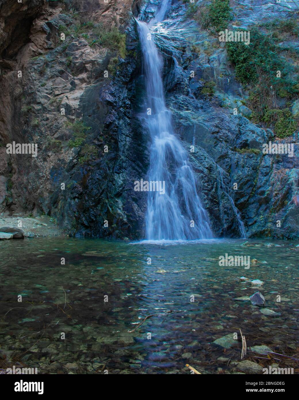 Vertical shot of a waterfall coming down the rocks Stock Photo - Alamy