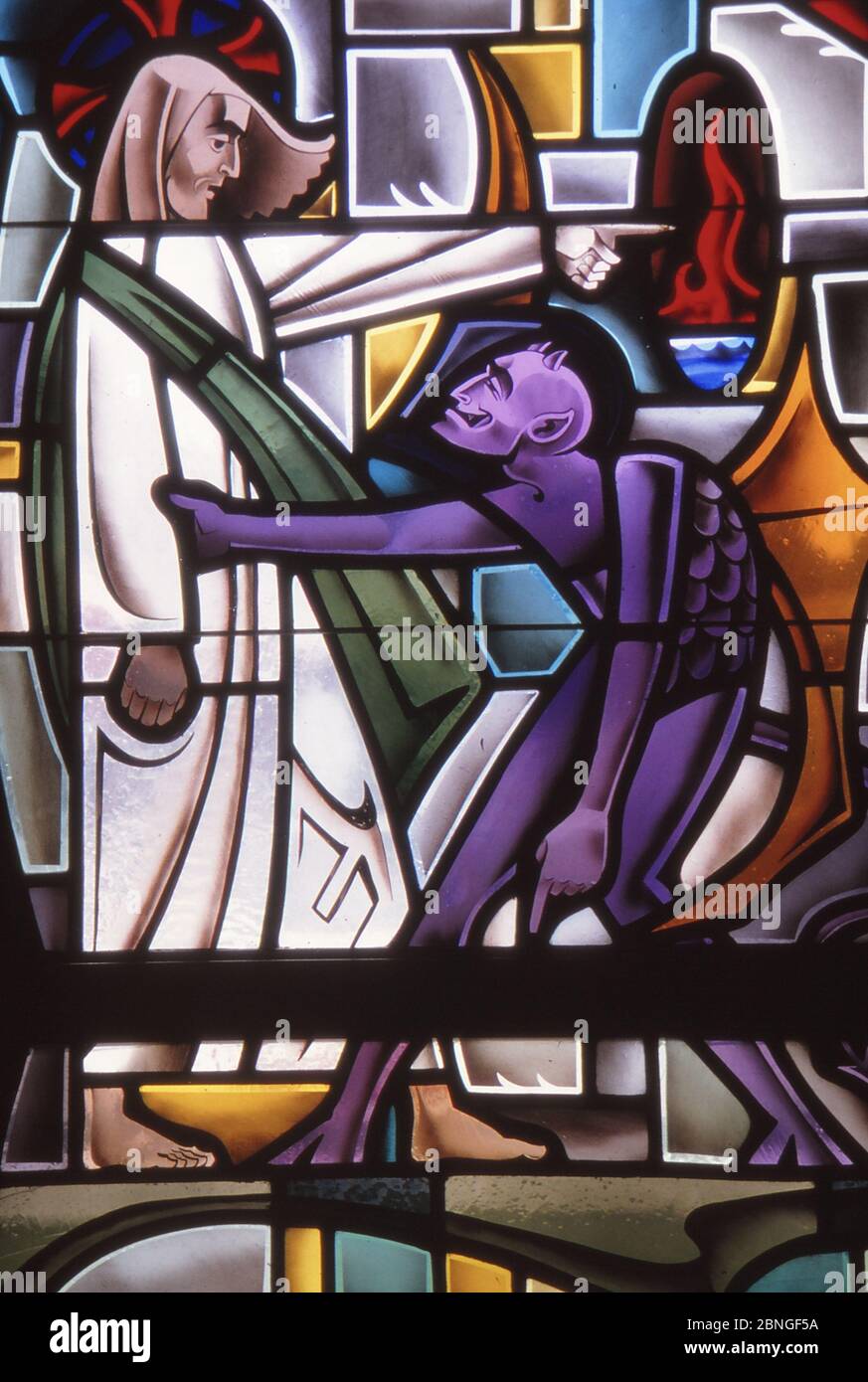 LOS ANGELES, UNITED STATES - Jun 17, 1985: Stained Glass depiction of Devil tempting Jesus in the desert. Stock Photo
