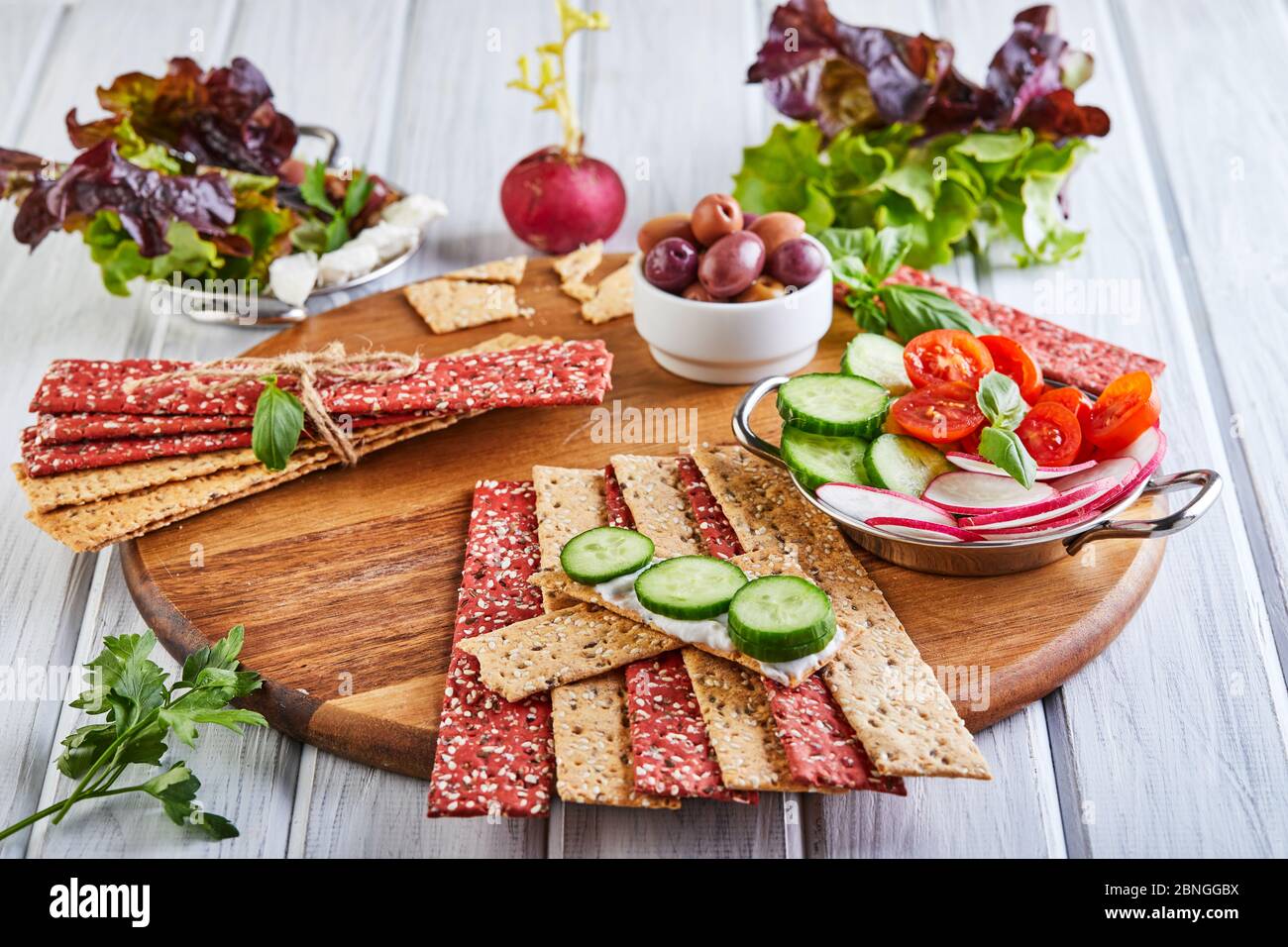 Beetroot and rye flour crackers with vegetables for making snacks on a ...