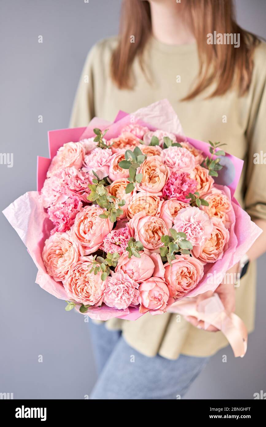 Beautiful bouquet of mixed flowers in womans hands. the work of the