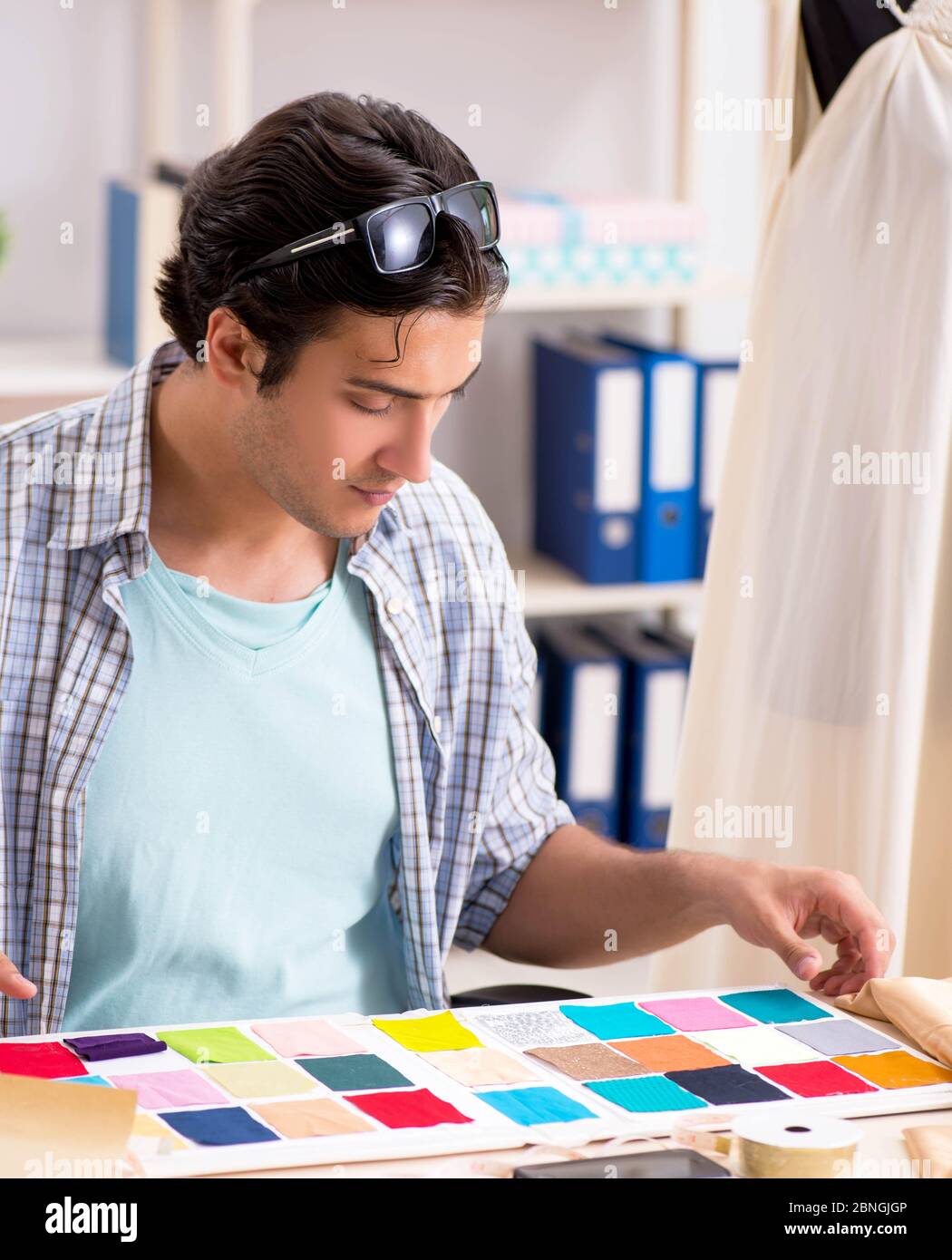 The young handsome tailor working in his workshop Stock Photo - Alamy