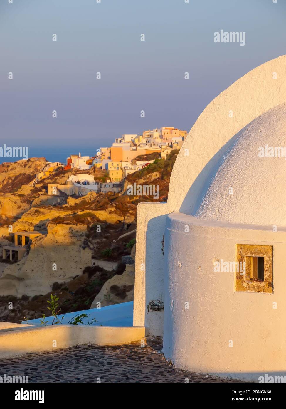 Amazing sunrise Santorini view with cave houses. Santorini island. Cyclades, Greece. Stock Photo