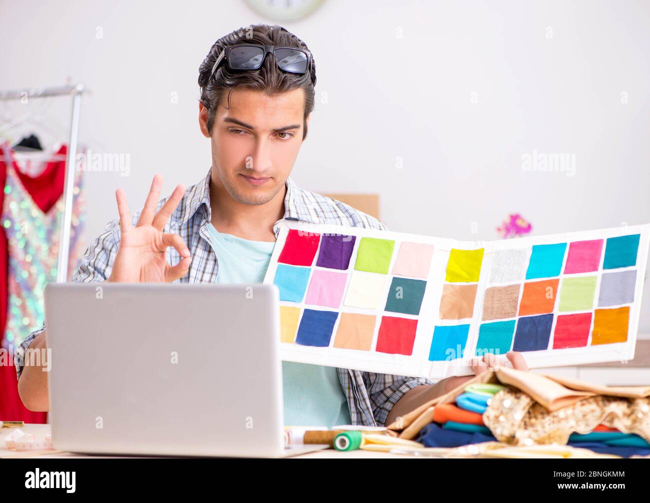The young handsome tailor working in his workshop Stock Photo - Alamy