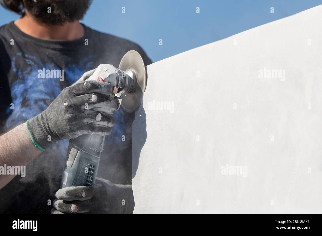 worker cutting stone with grinder Stock Photo Alamy
