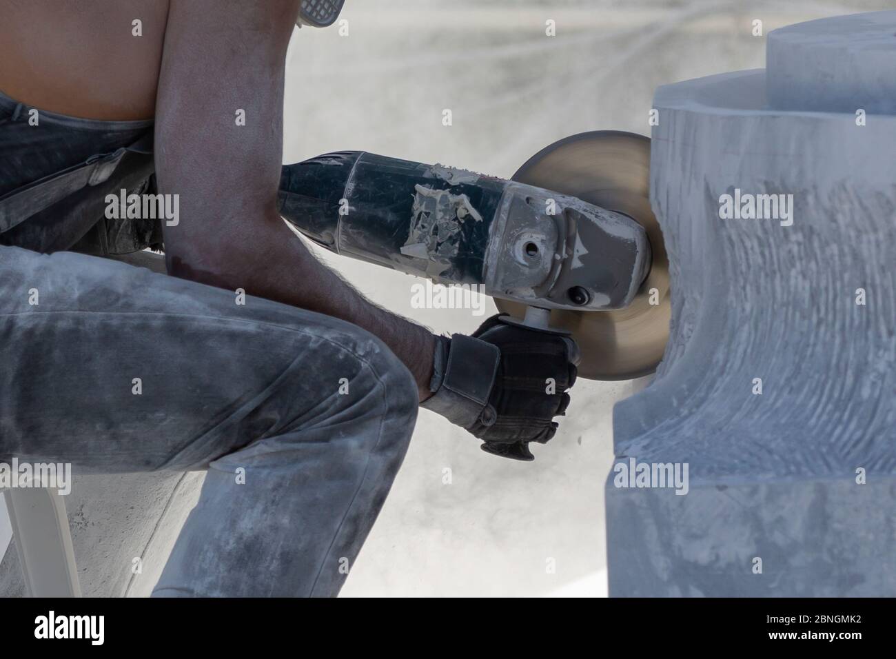 worker cutting stone with grinder Stock Photo Alamy