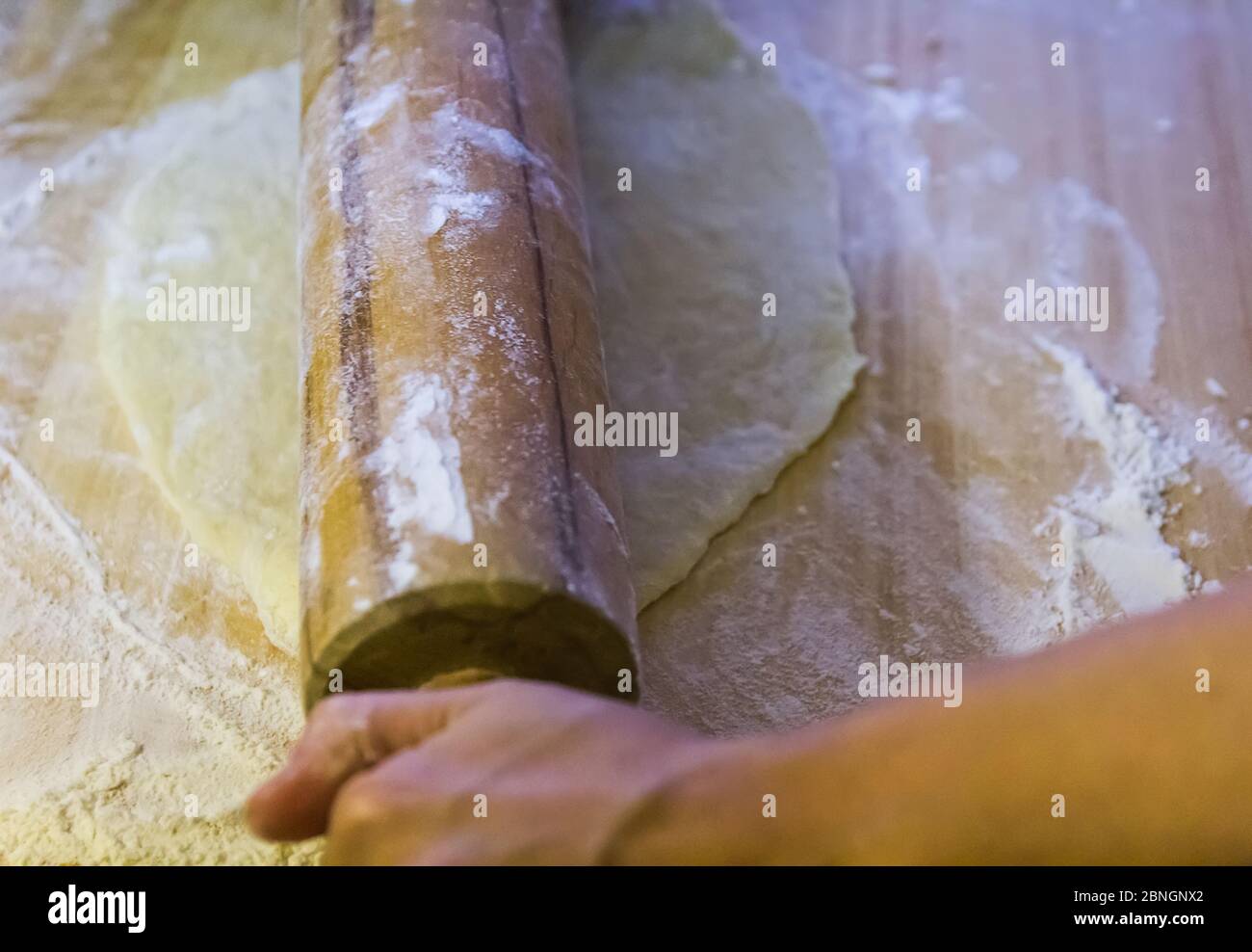 Woman hands kneading, rolling yeast dough on table with flour ...