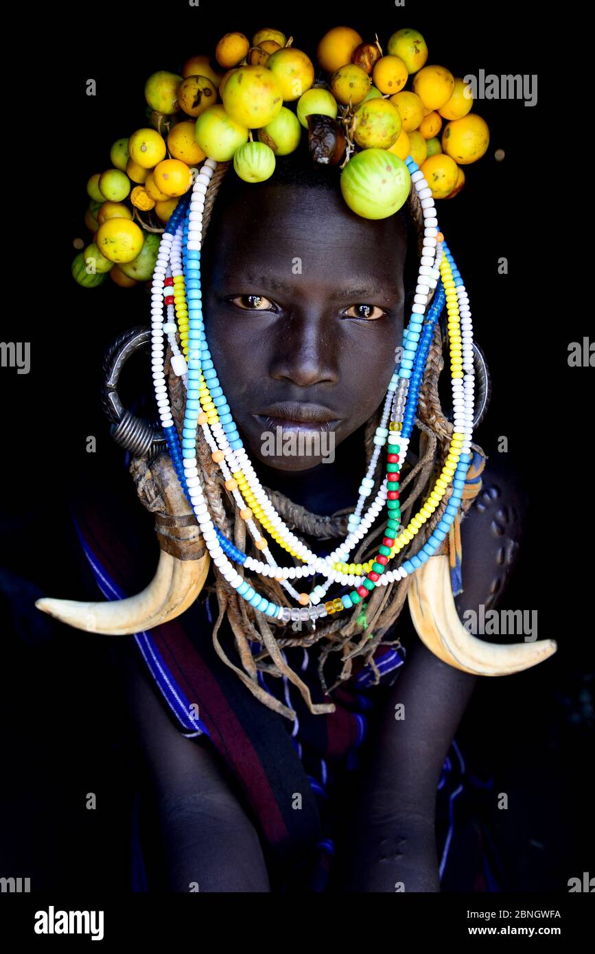 Young girl wearing traditional headdress, Mursi tribe, Mago National Park. Omo Valley, Ethiopia. Stock Photo