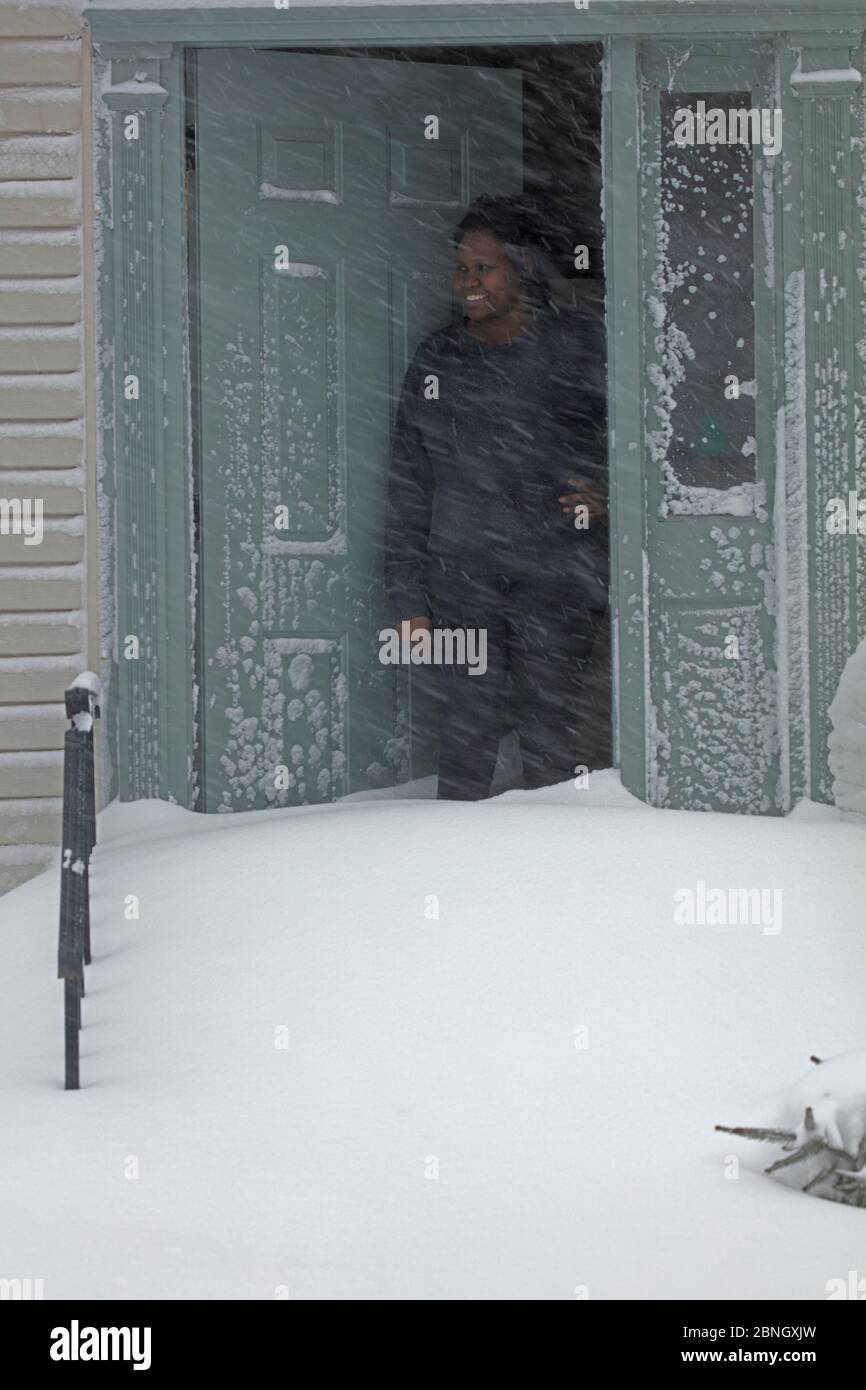 Woman looking out att Winter storm Jonas, Washington DC area, January 2016. This storm had winds up to 75 mph, over 30 people killed, up to 42 inches Stock Photo