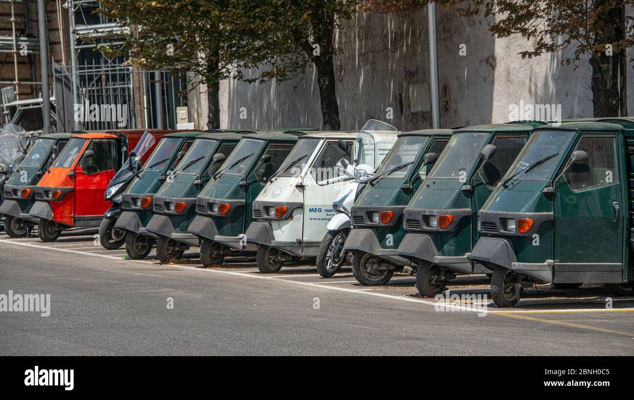 Piaggio Ape50 in a row  in Rome. Piaggio Ape is a three-wheeled light commercial vehicle first produced in 1948 by Piaggio Stock Photo