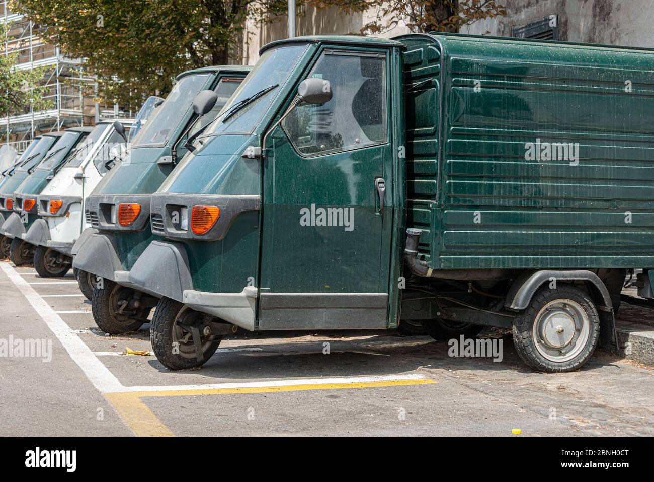 Piaggio Ape50 in a row  in Rome. Piaggio Ape is a three-wheeled light commercial vehicle first produced in 1948 by Piaggio Stock Photo