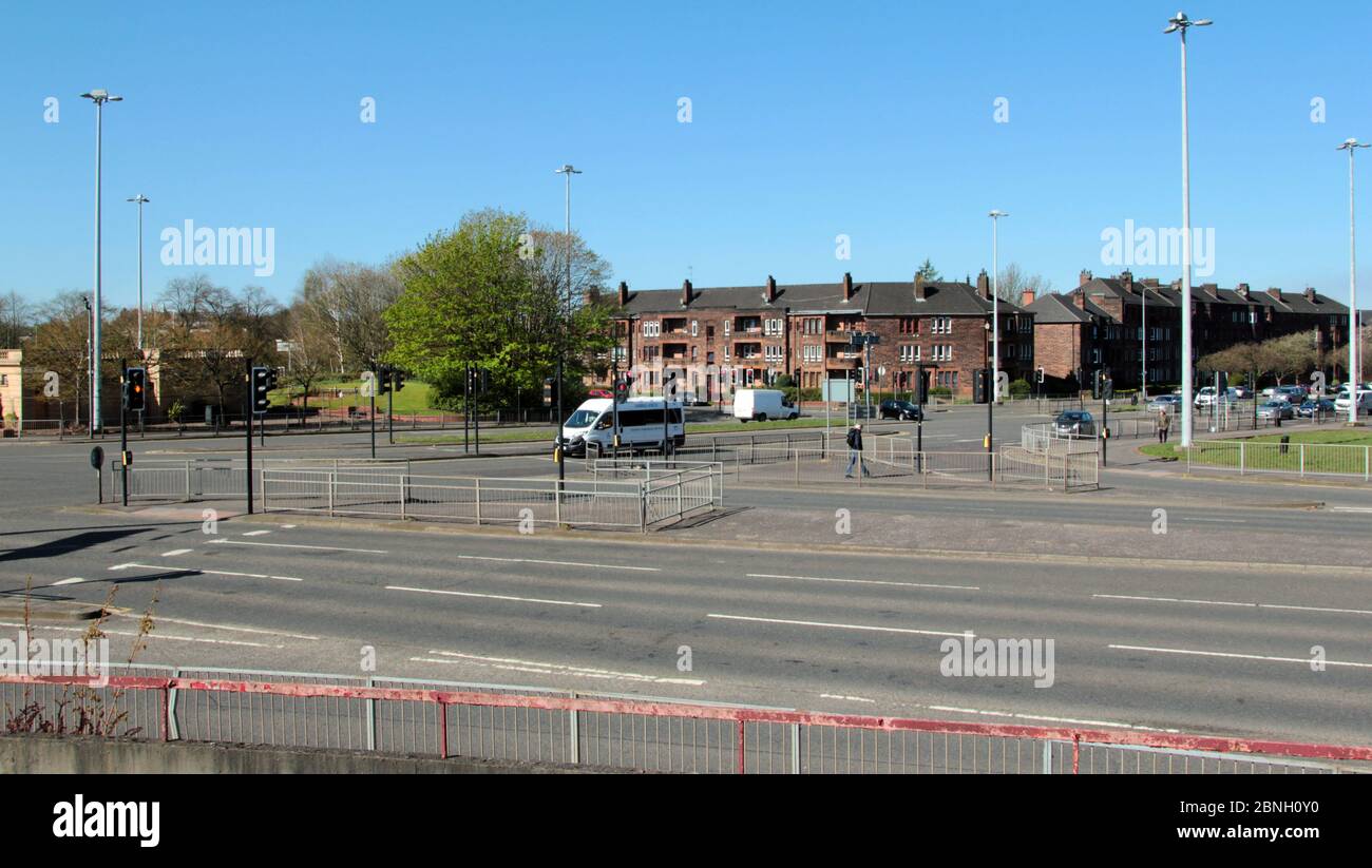 This road junction is Anniesland Cross in Glasgow, and is usually overrun by cars, bus, lorries, but now it is empty and deserted because of the Covid-19, coronavirus pandemic that is raging through Britain and people are in a lockdown and stay at home mode for the time being. May 2020. ALAN WYLIE/ALAMY© Stock Photo