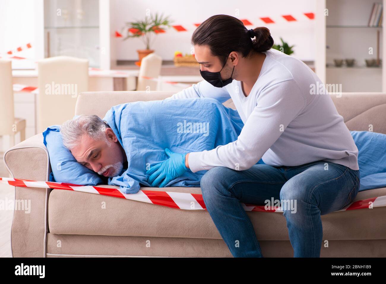 Father and son in the coronavirus concept at home Stock Photo