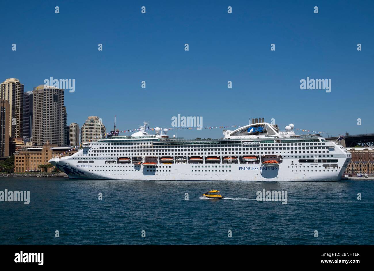 Looking tacross Sydney Harbour towards the  Sun Princess  cruise liner docked at the Overseas Passenger Terminal, Sydney, New South Wales, Australia. Stock Photo