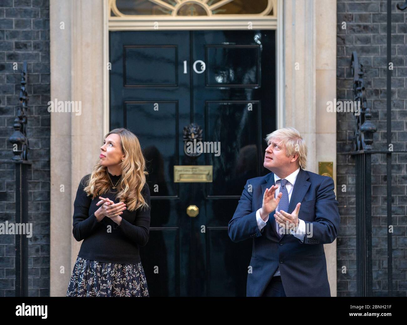 Prime Minister, Boris Johnson, is joined on the steps of 10 Downing Street by  fiancee Carrie Symonds to 'Clap for carers' supporting the NHS. Stock Photo