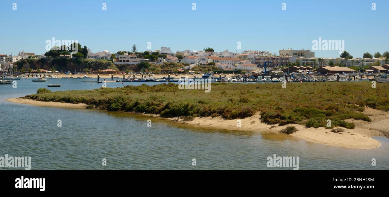 Saltmarsh and estuarine harbour at high tide with moored sailing yachts, Alvor, near Portimao, Algarve, Portugal, July 2013. Stock Photo