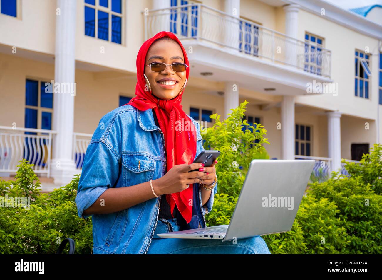 beautiful young black woman sitting alone with her laptop computer and ...