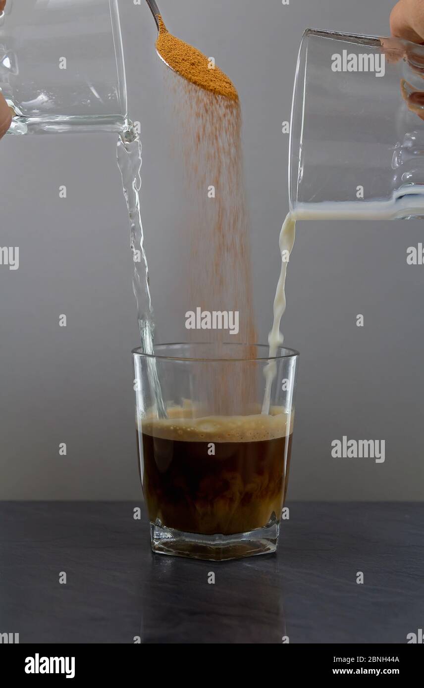 Coffee milk and water mix in small glass on stone desk Stock Photo Alamy