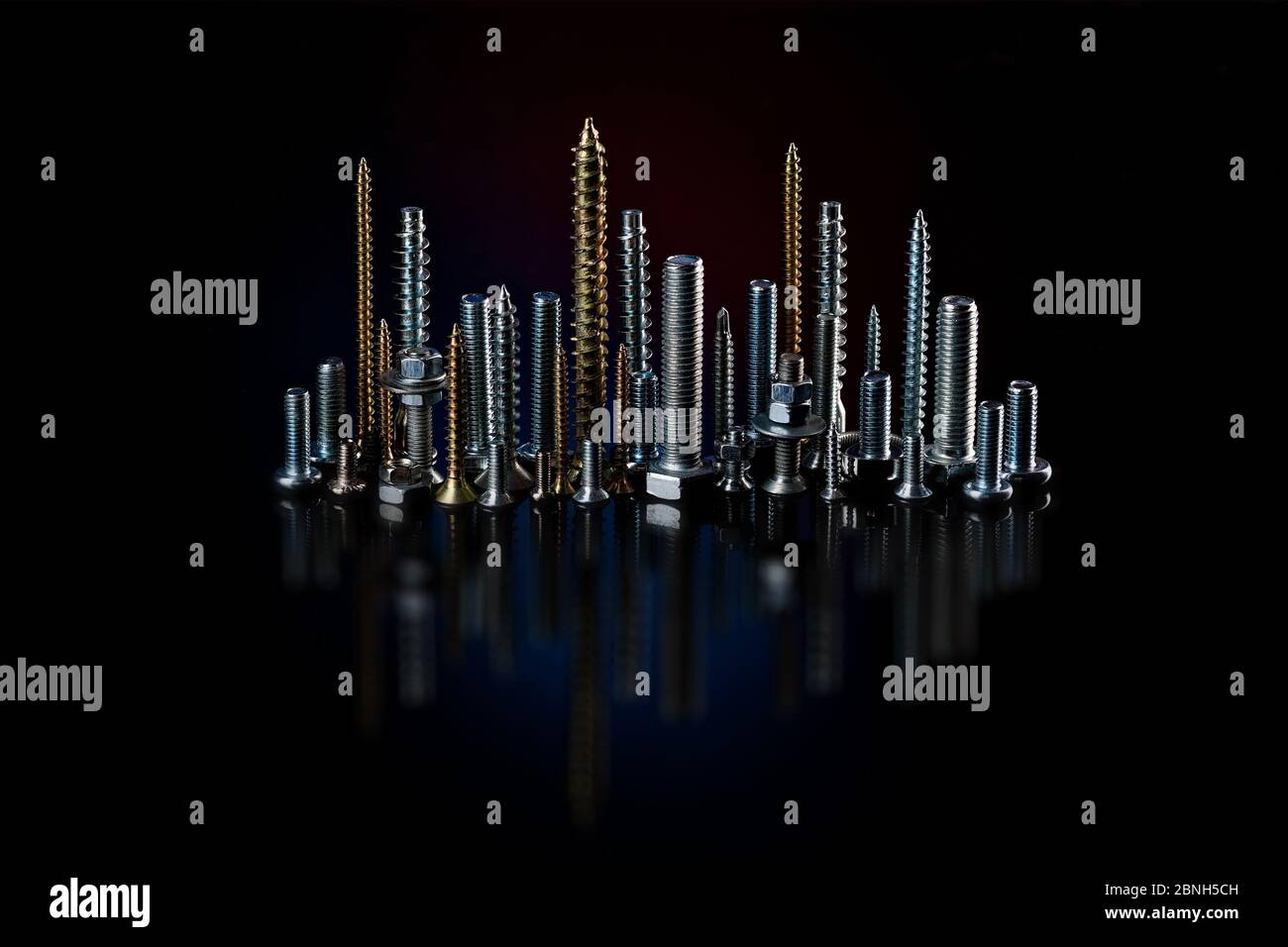 Screws and bolts on a black background. Small selftapping screws and