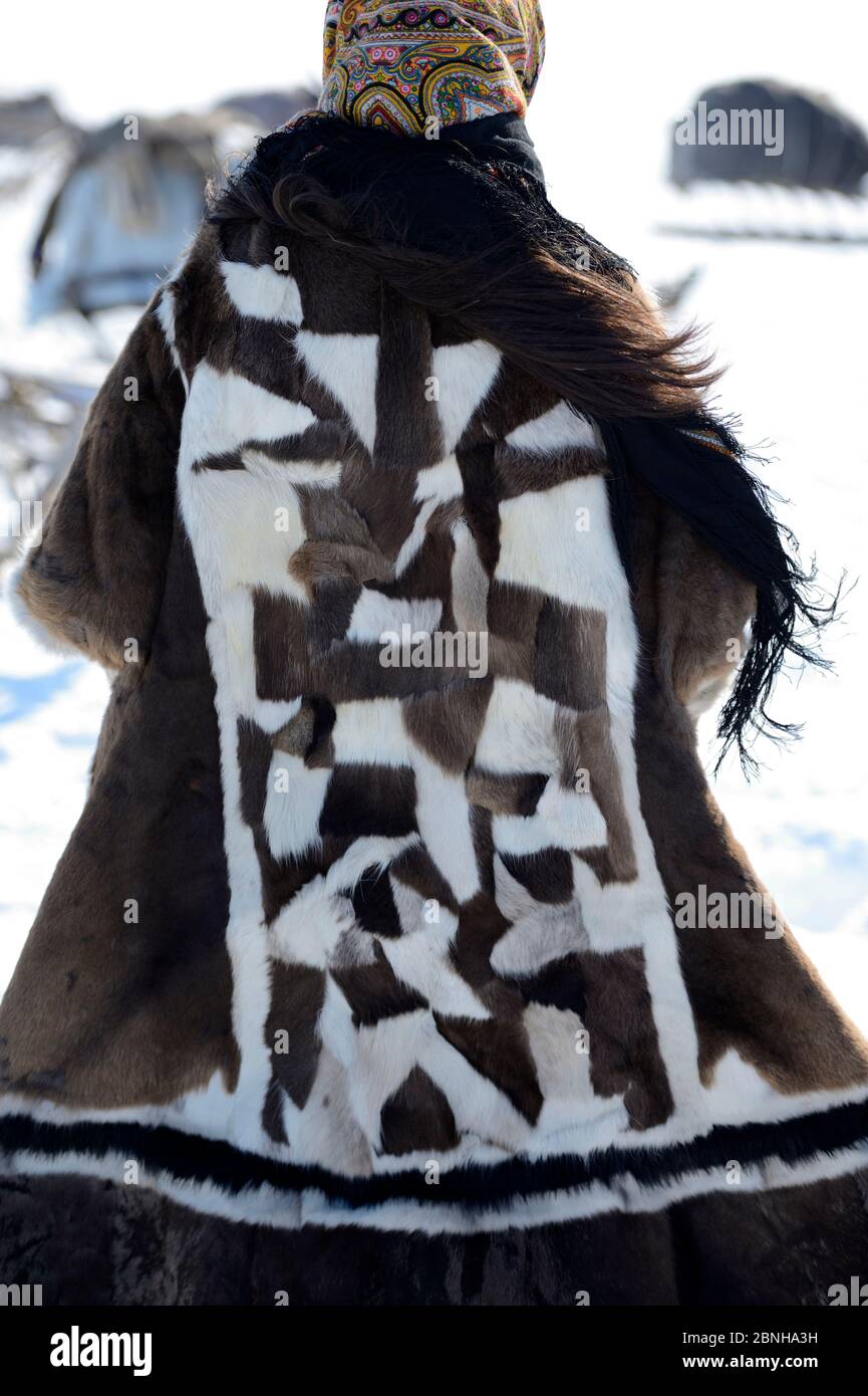 Nenet teenager dressed in traditional winter coat made with reindeer skin.  Yar-Sale district, Yamal, Northwest Siberia, Russia. April 2016. Stock Photo