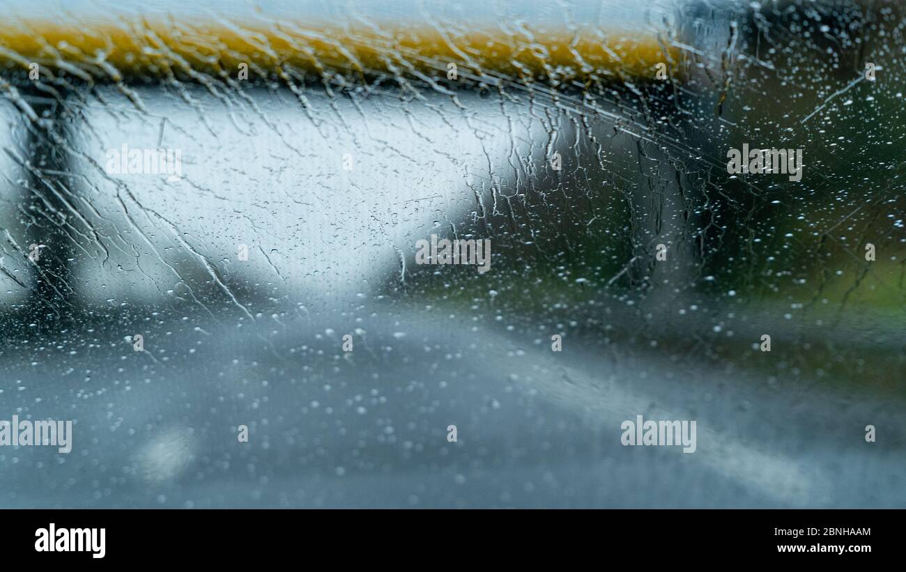 Heavy rain on a windscreen whilst driving on a motorway Stock Photo