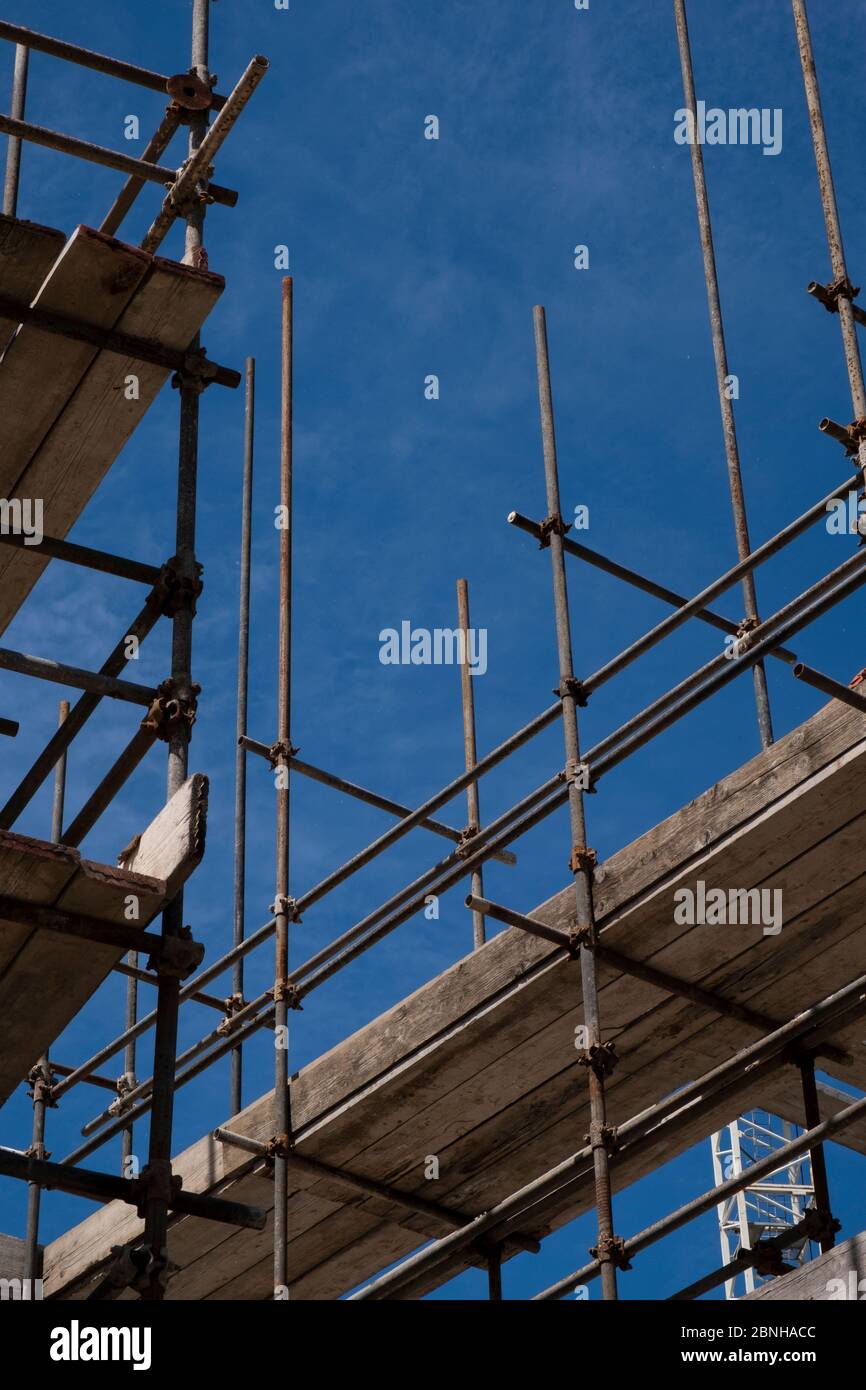 scaffolding building construction site against blue sky Stock Photo - Alamy