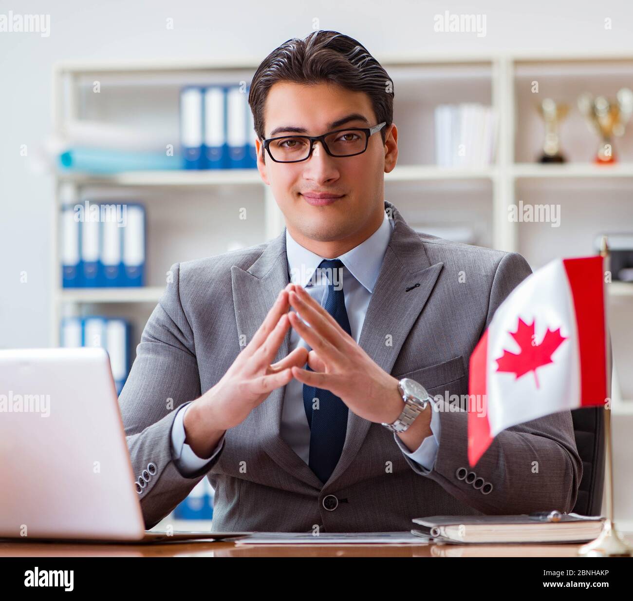 The businessman with canadian flag in office Stock Photo - Alamy