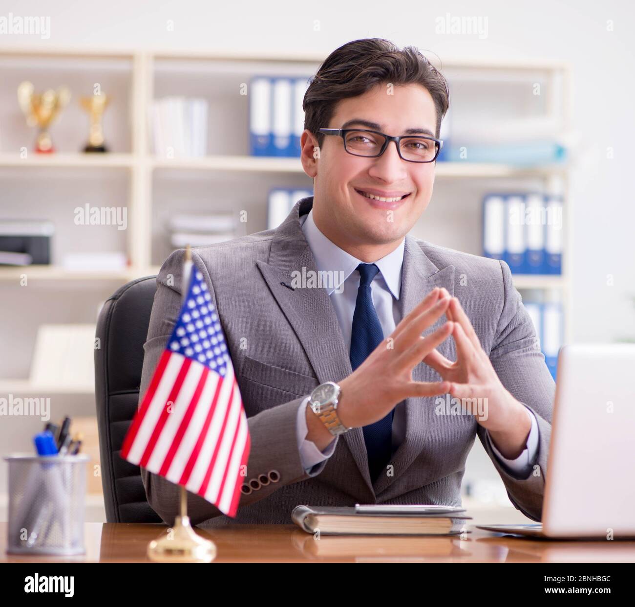 The businessman with american flag in office Stock Photo - Alamy