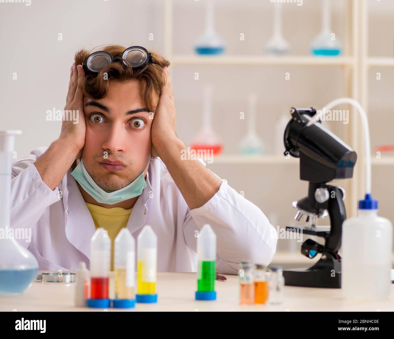 The funny crazy chemist doing experiments and tests Stock Photo