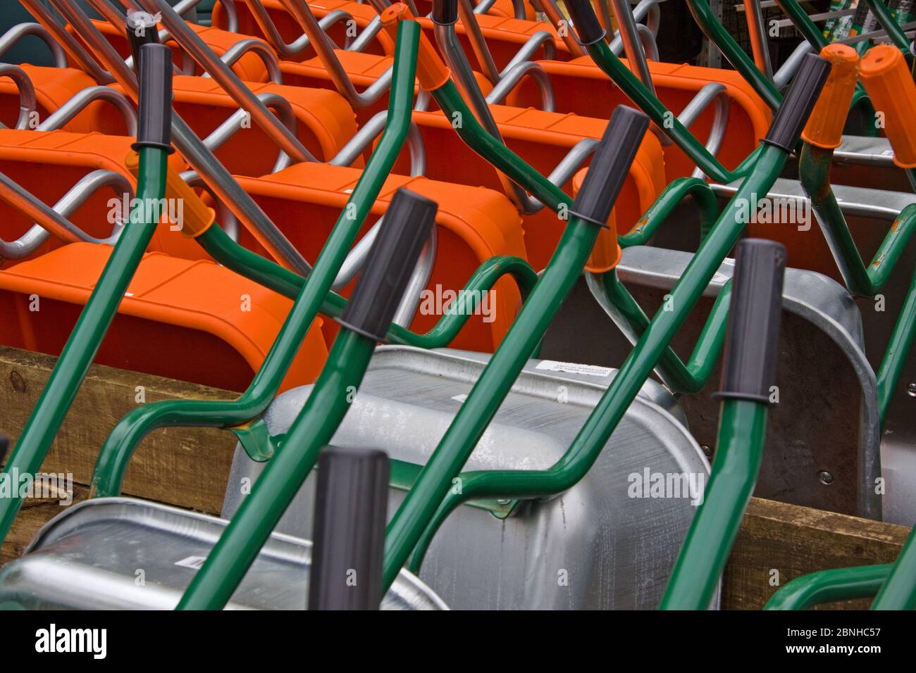 Wheelbarrows fresh from the production line stacked ready for the retail market Stock Photo