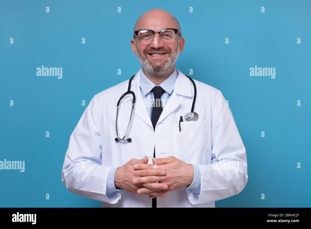 Happy smiling mature doctor hi-res stock photography and images - Alamy