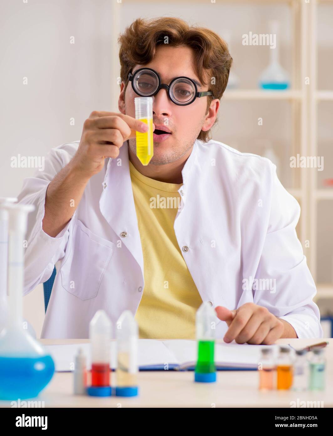 The funny crazy chemist doing experiments and tests Stock Photo