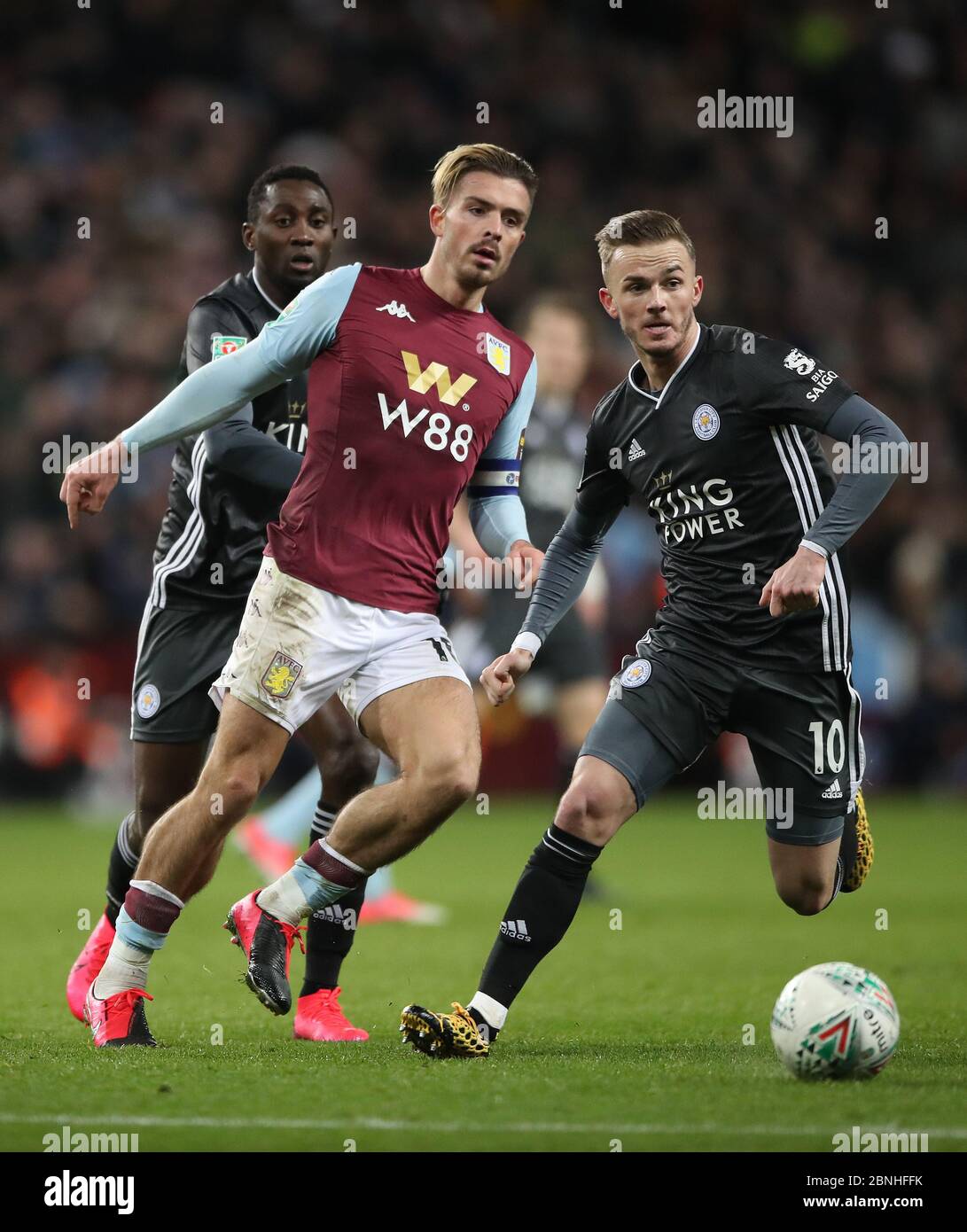 Aston Villa's Jack Grealish gets his pass away as he holds off challenge from Leicester City's James Maddison during the Carabao Cup Semi Final, second leg match at Villa Park, Birmingham. Stock Photo