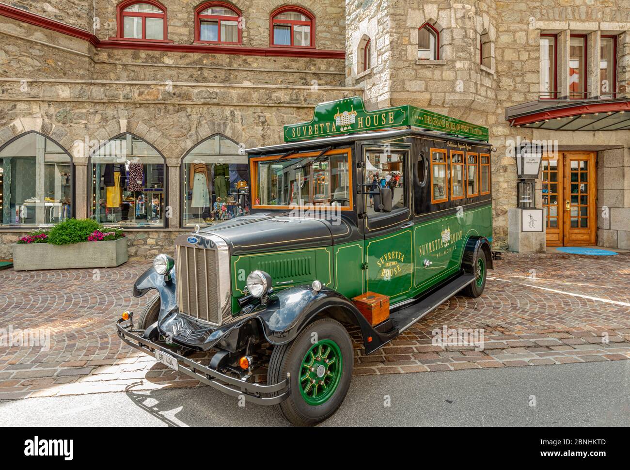 Suvretta House Hotel Ford Vintage bus in front of the Badrutts Palace Hotel, St.Moritz, Grisons, Switzerland Stock Photo
