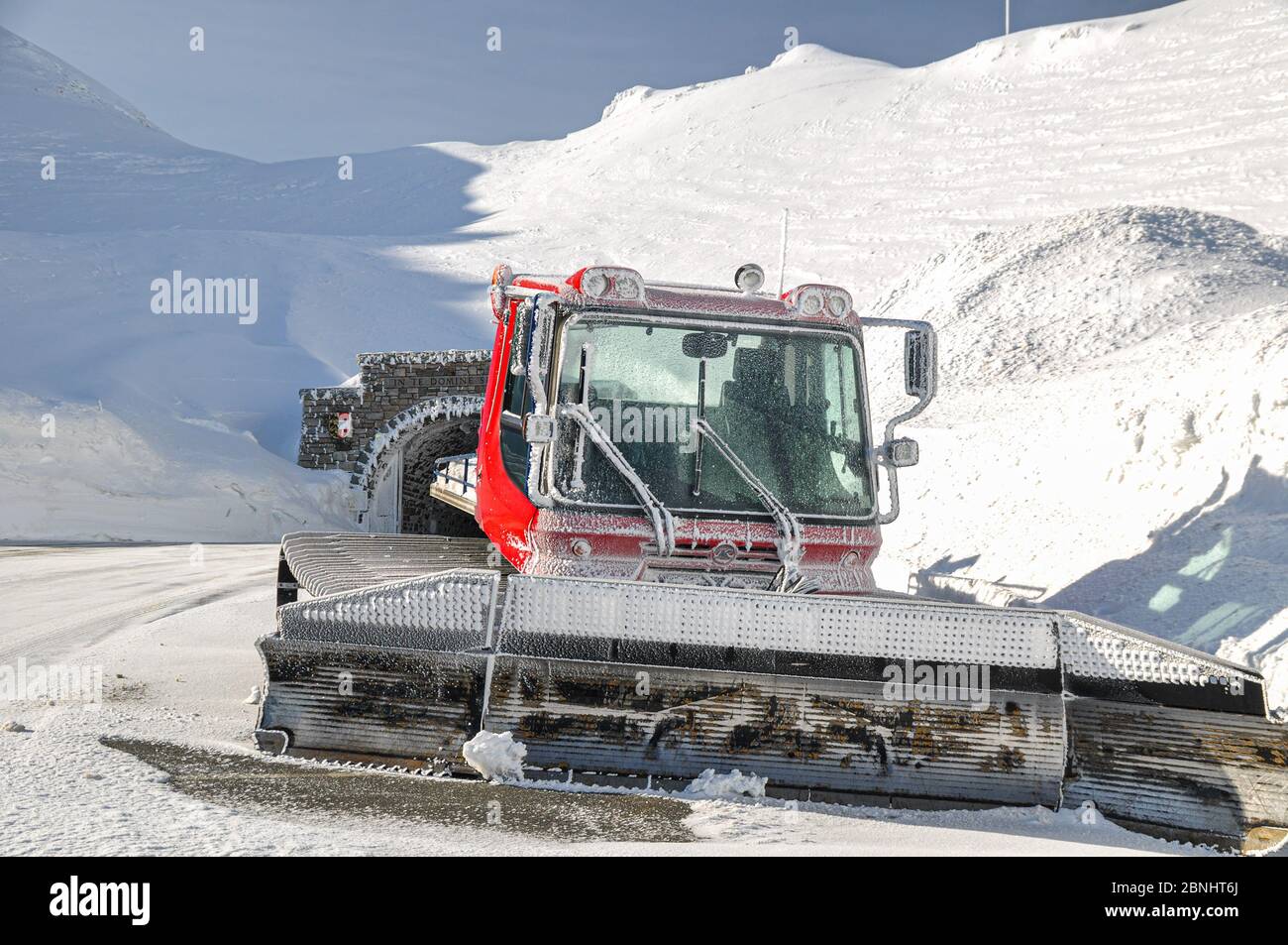 Close-up of Ratrack machine at the High alpine Road  in Austria in Spring Alpine mountains with snow. Stock Photo