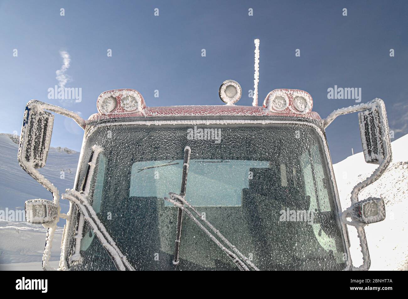 Close-up of Ratrack machine at the High alpine Road  in Austria in Spring Alpine mountains with snow. Stock Photo