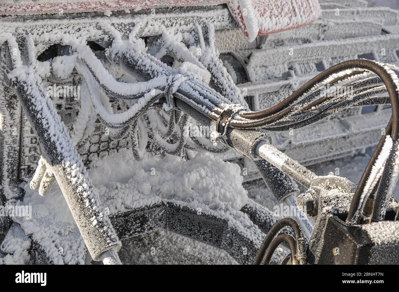 Close-up Frozen hydraulic pipes of a Ratrack machine at the High alpine Road  in Austria Stock Photo