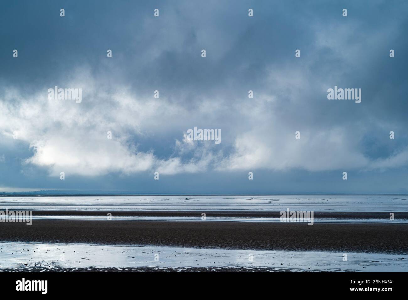 Pastel shades of sea and sandy beach of the sea shore by the Bristol Channel at Burnham-on-Sea, Somerset, UK Stock Photo