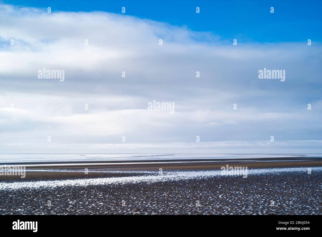 Pastel shades of sea and sandy beach of the Bristol Channel at Burnham-on-Sea seashore, Somerset, UK Stock Photo
