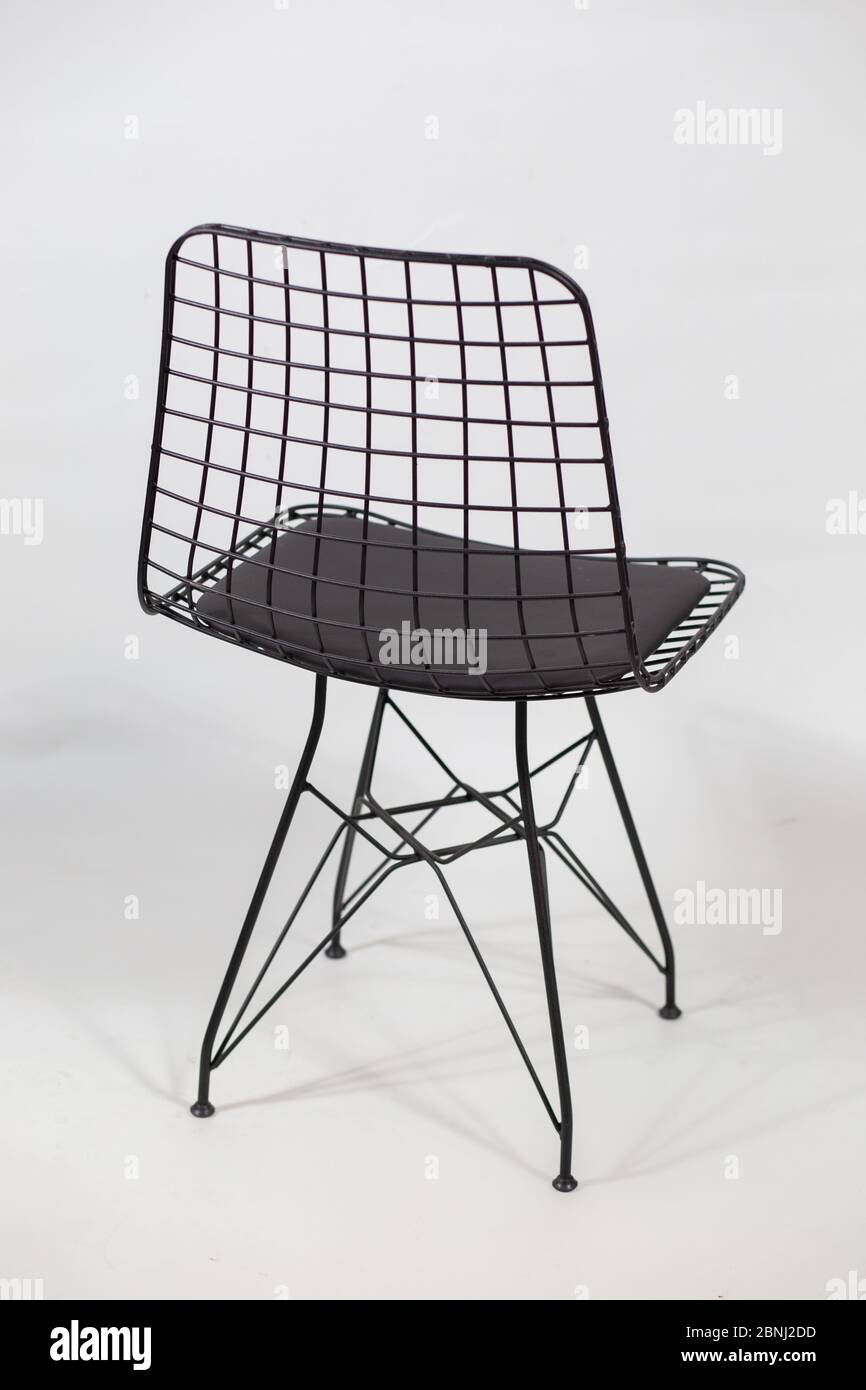 Vertical shot of a futuristic chair with a chain in the back behind a ...