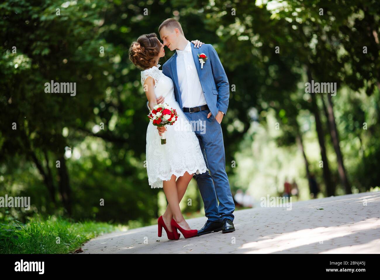 Wedding couple, happy newlyweds and husband hugging in green park Stock ...