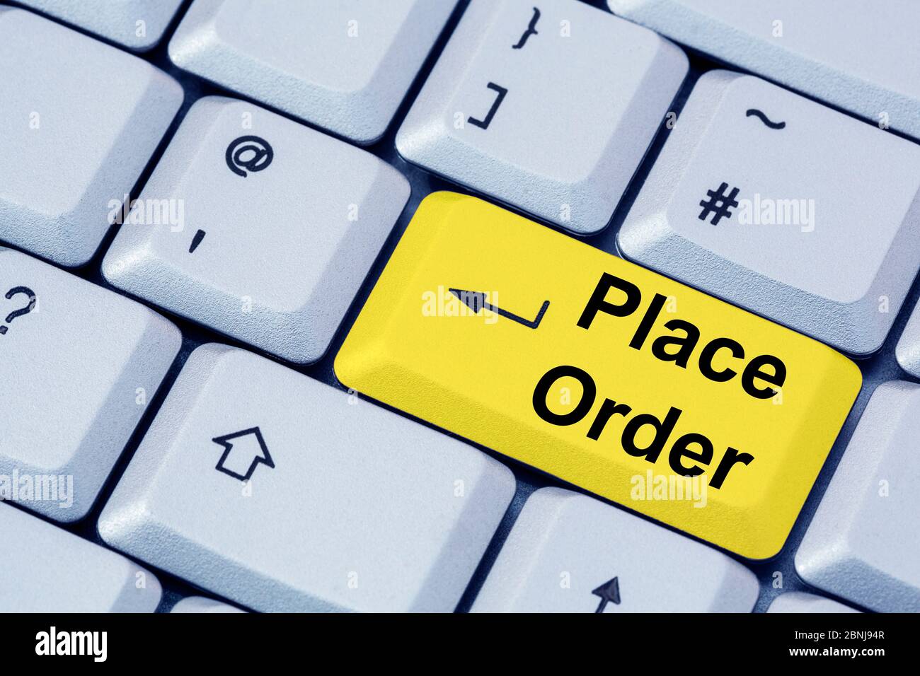 A computer keyboard with words PLACE ORDER on a yellow enter key.  Online shopping concept. Stock Photo
