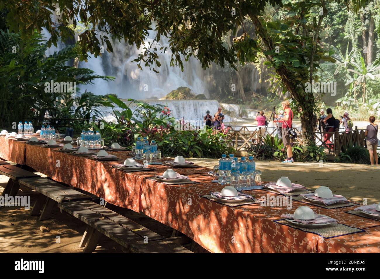 Restaurant tables outdoors with place settings at Tat Kuang Si or Xi waterfalls. Luang Prabang, Louangphabang province, Laos, southeast Asia Stock Photo