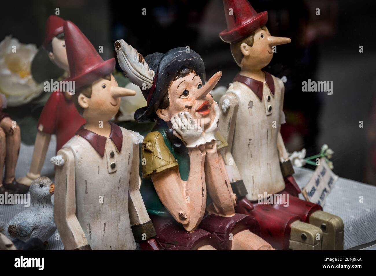 Siena, Italy, April 2018: Wooden statue of Pinocchio with donkey ears and long nose. Pinocchio is the protagonist of a famous Italian fairy tale Stock Photo