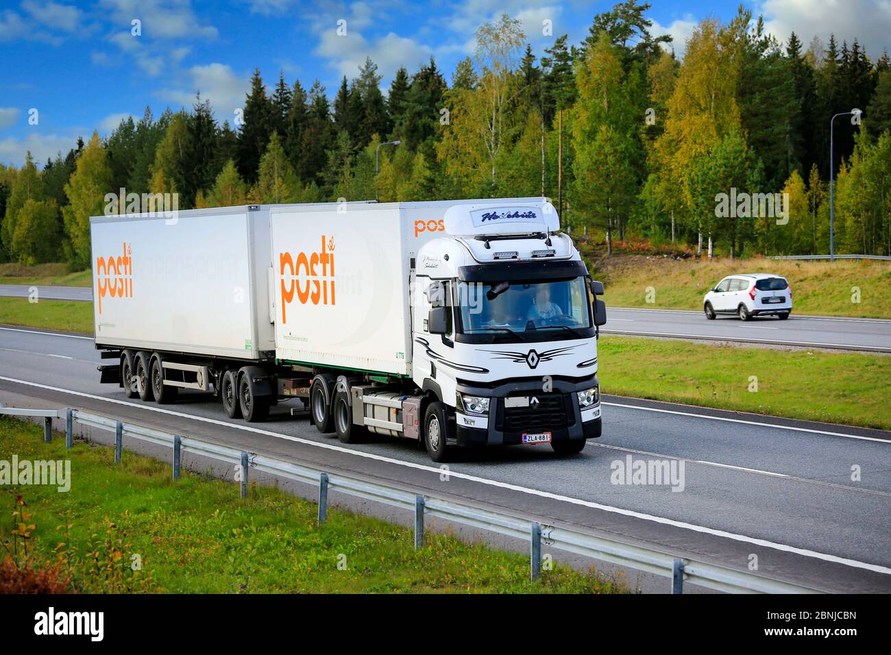 White Renault Trucks T truck for the deliveries of Finnish Post, Posti Kuljetus Oy at speed on Motorway 1. Salo, Finland. September 28, 2019. Stock Photo