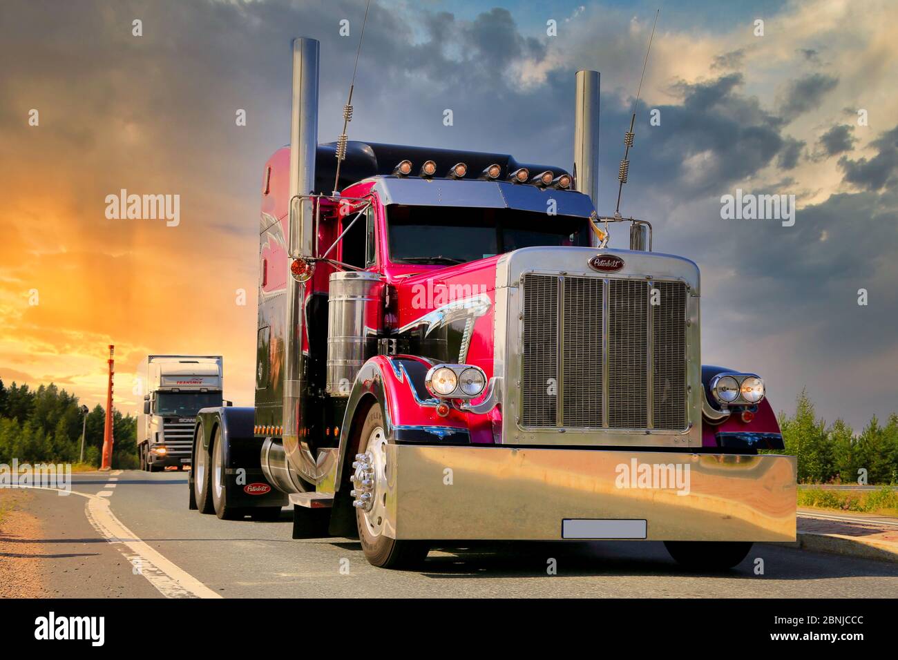 American Show truck tractor Peterbilt 379 bobtailing with sunset sky background. Stock Photo