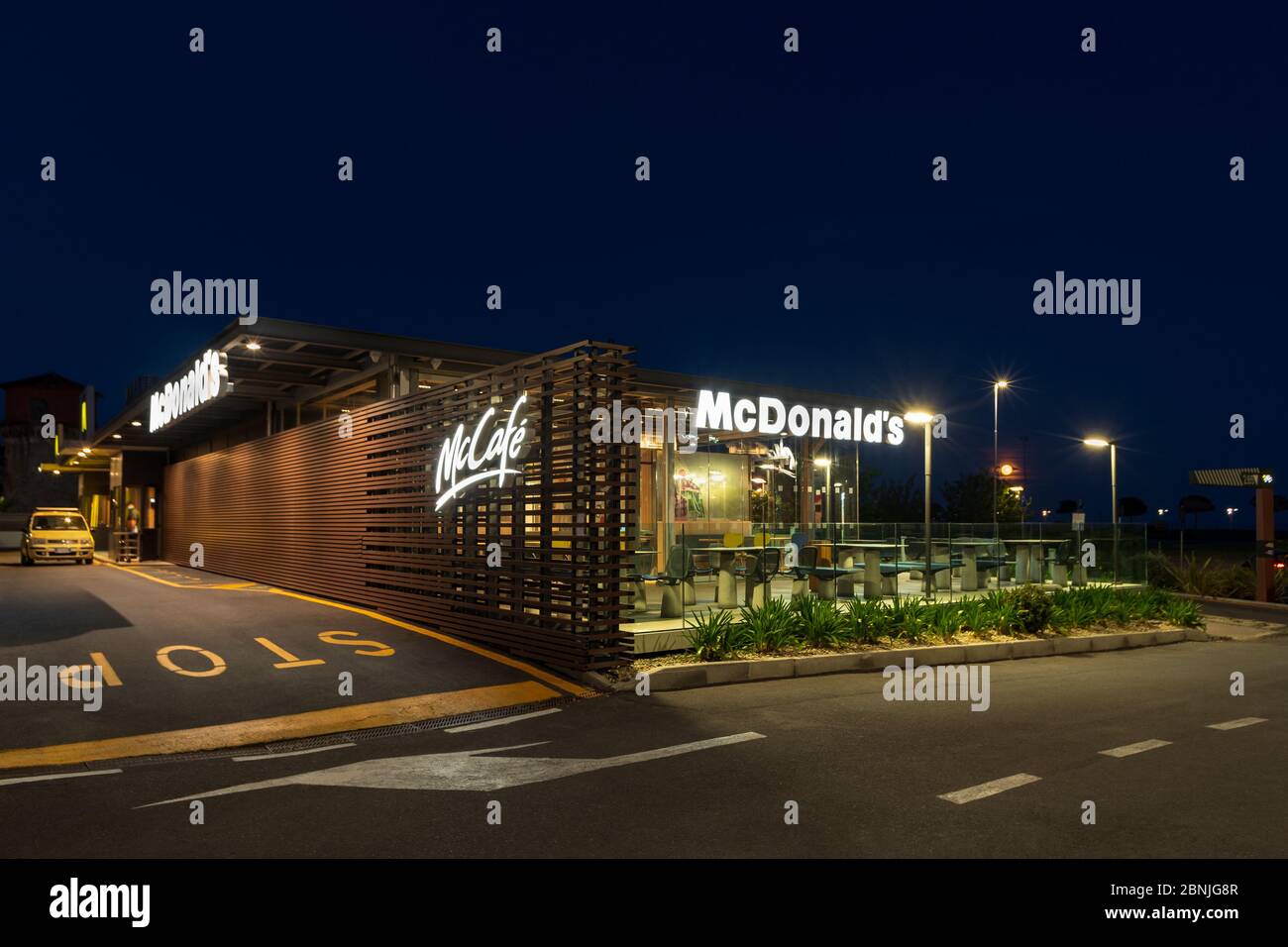 McDonald's fast food restaurant with drive through at night in Imperia ...