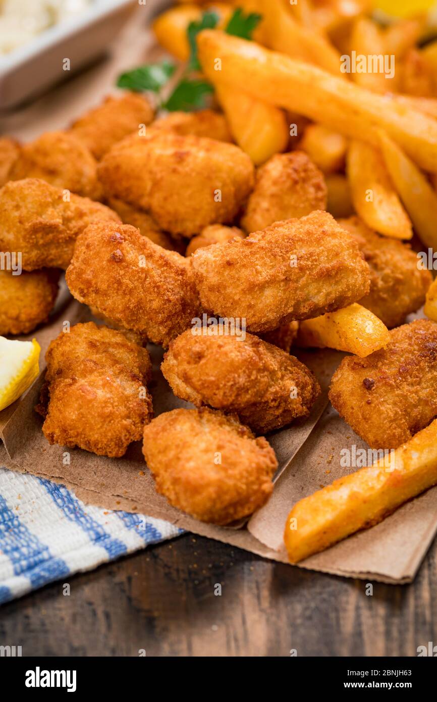 Crispy Fish Bites Snack Size. Deep Fried Pollock Fish Fingers with Tartar Dipping Sauce on a